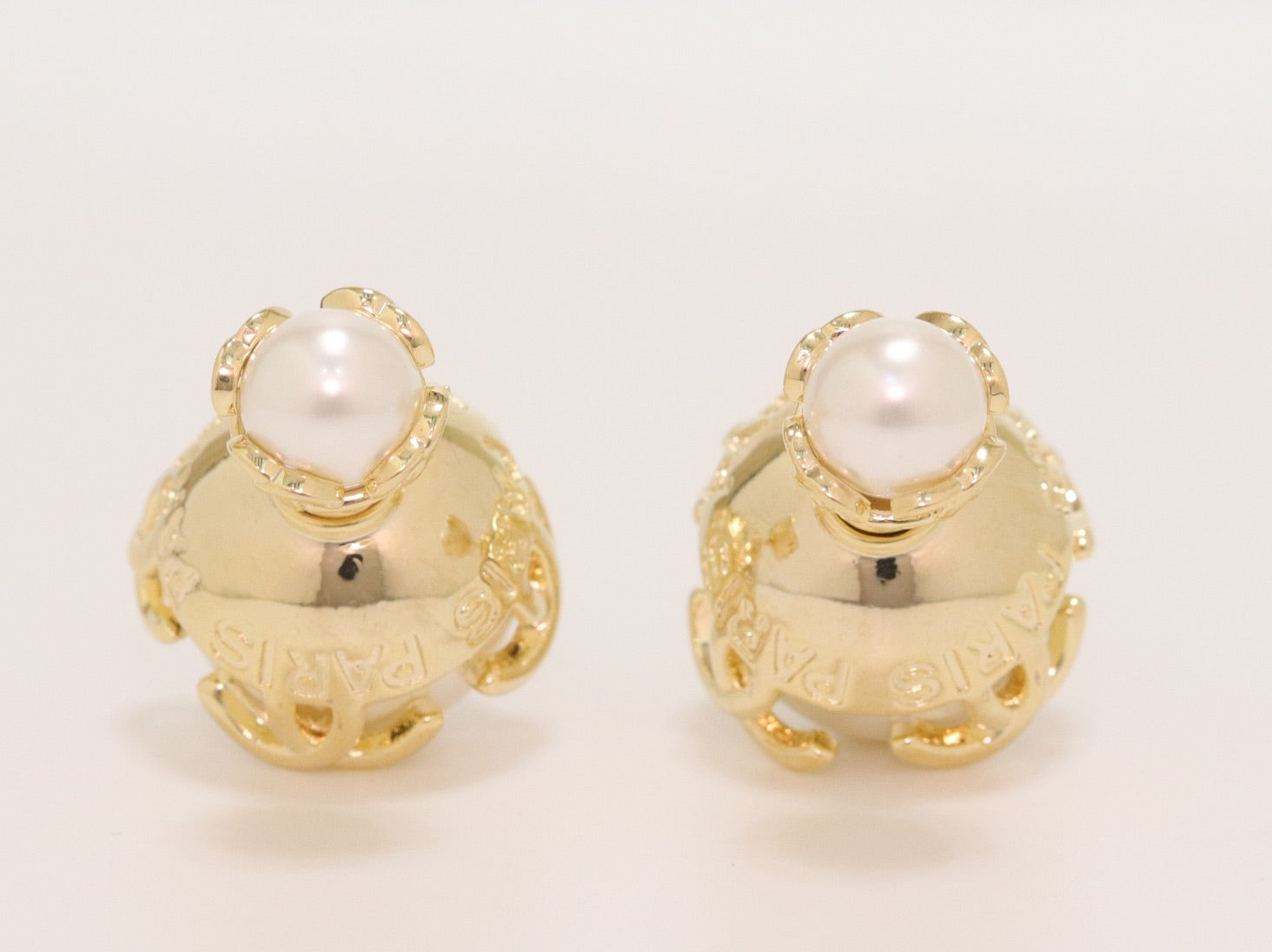 Double C white pearl studs in gold finish