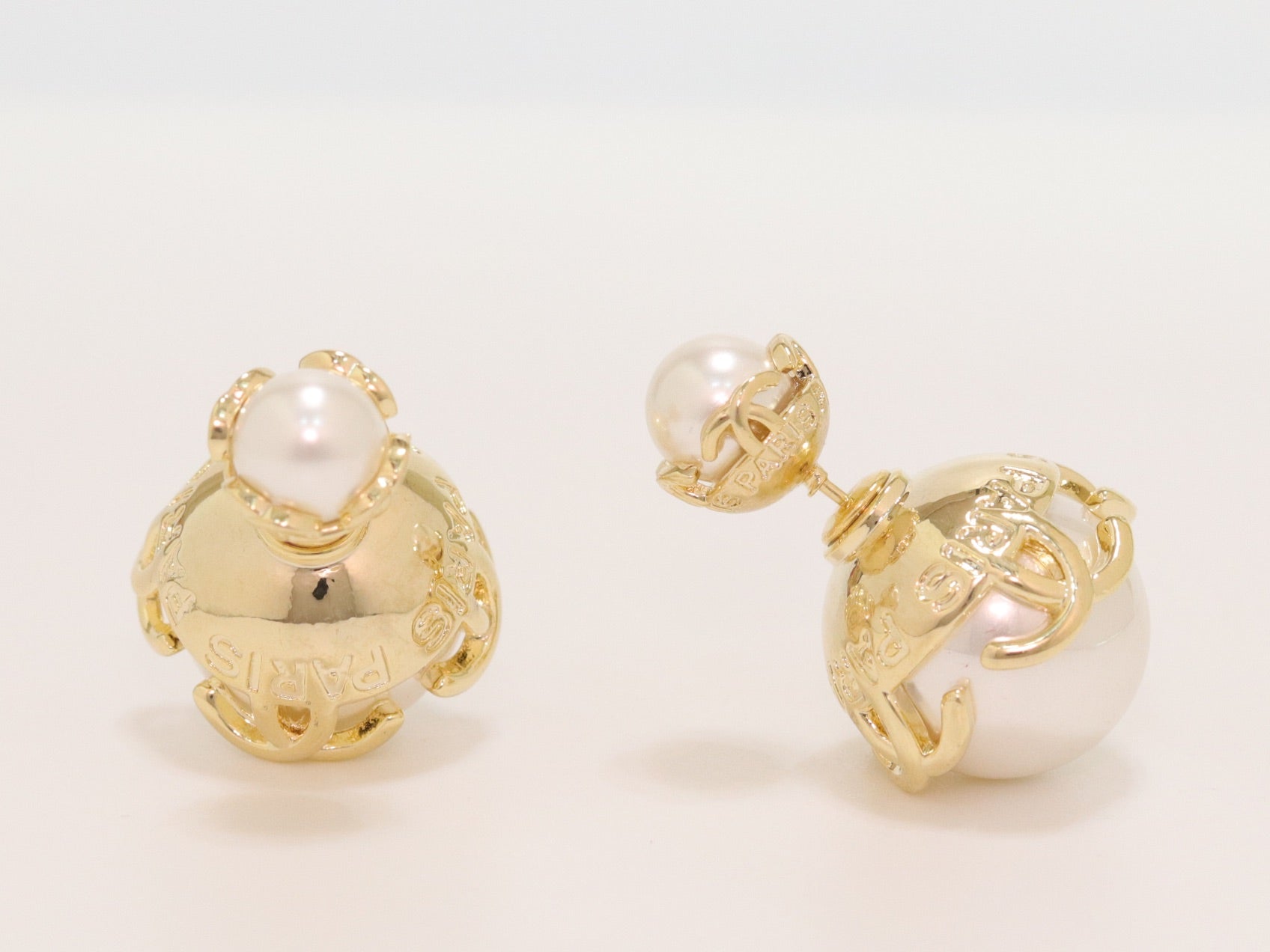 Double C white pearl studs in gold finish