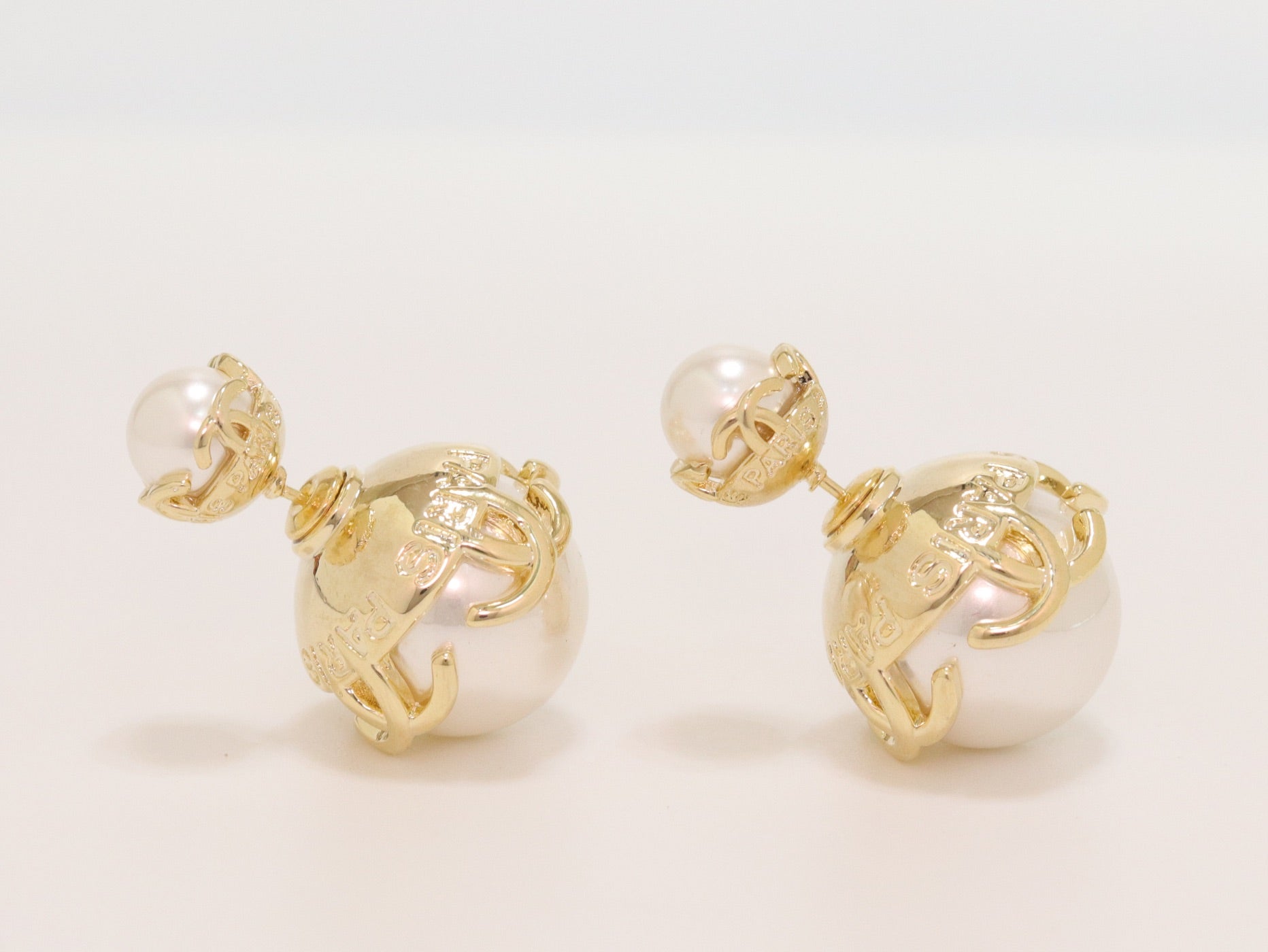 Double C white pearl studs in gold finish