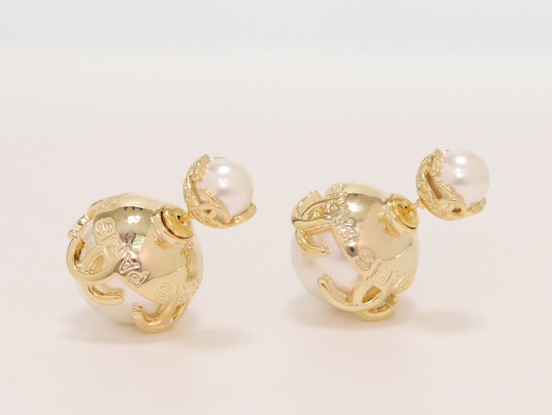 Double C white pearl studs in gold finish