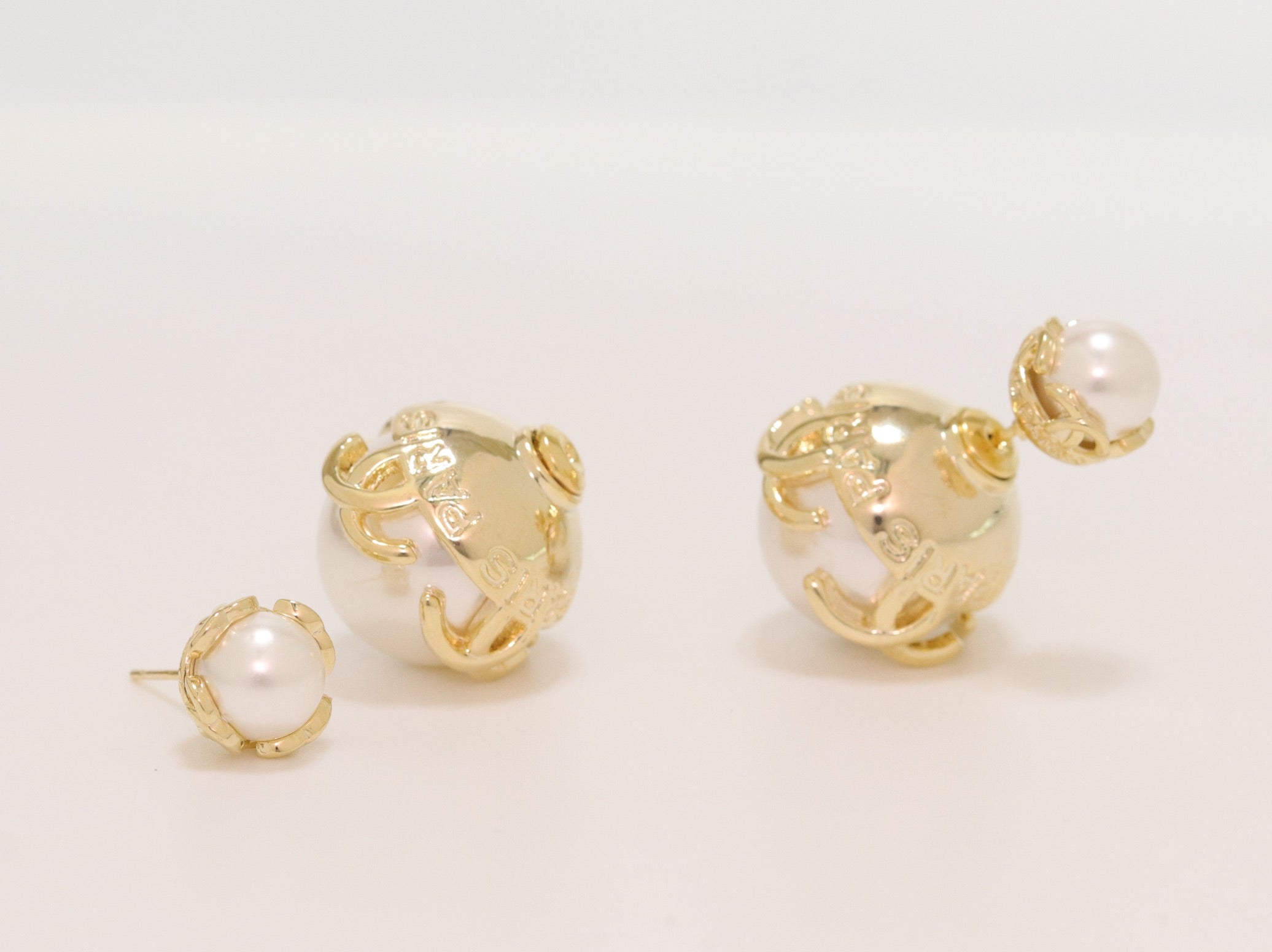 Double C white pearl studs in gold finish