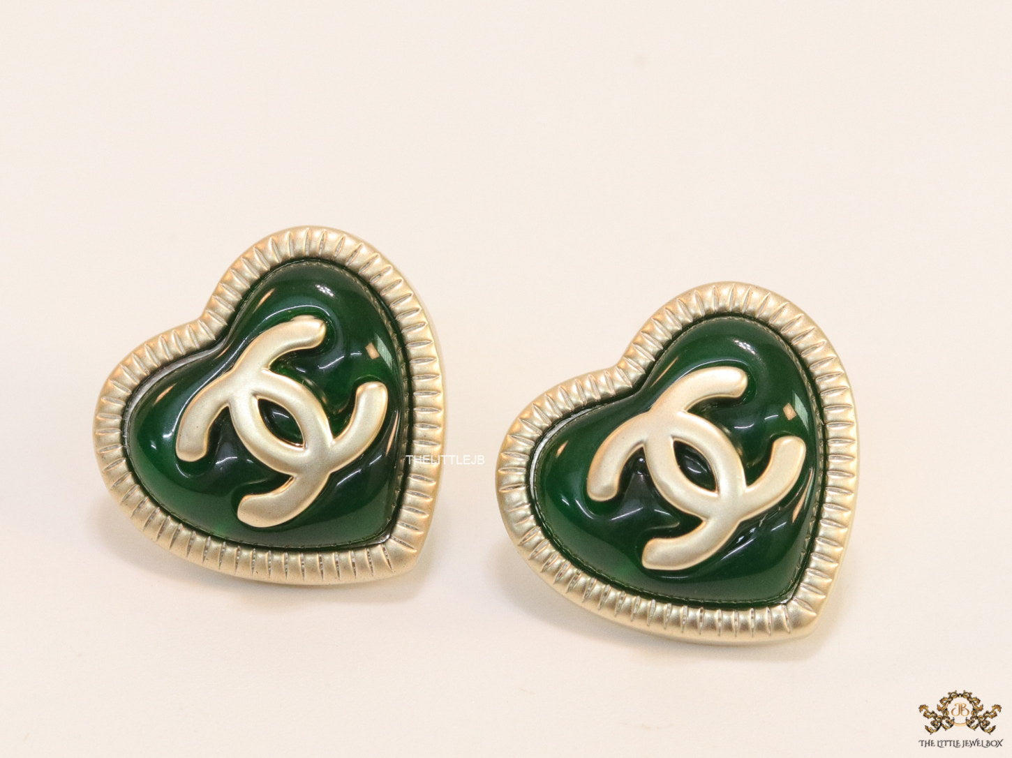 Heart shape twin C motif golden studs with deep green base