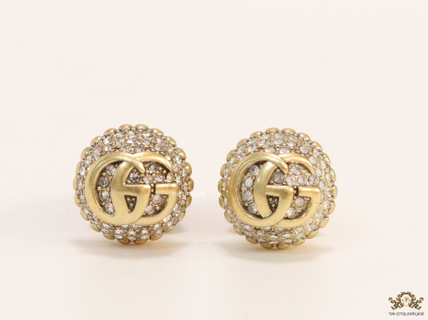 Gold plated cz softy shape studs with twin G motif