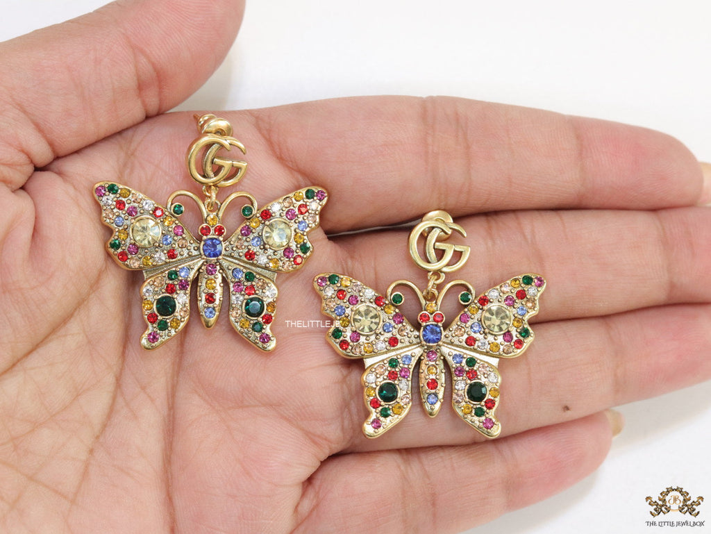 Gold plated twin G motif earrings with multi cz butterfly drops