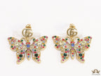 Gold plated twin G motif earrings with multi cz butterfly drops