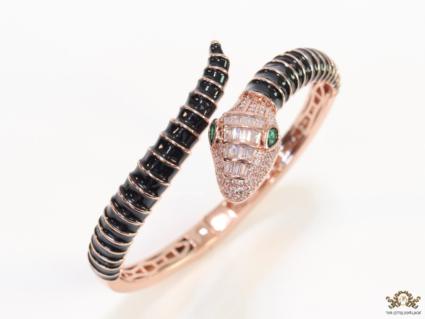 Top open serpentine bracelet in black enamel with rose gold plated details and cubic zirconia stones head