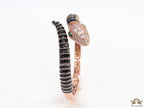 Top open serpentine bracelet in black enamel with rose gold plated details and cubic zirconia stones head
