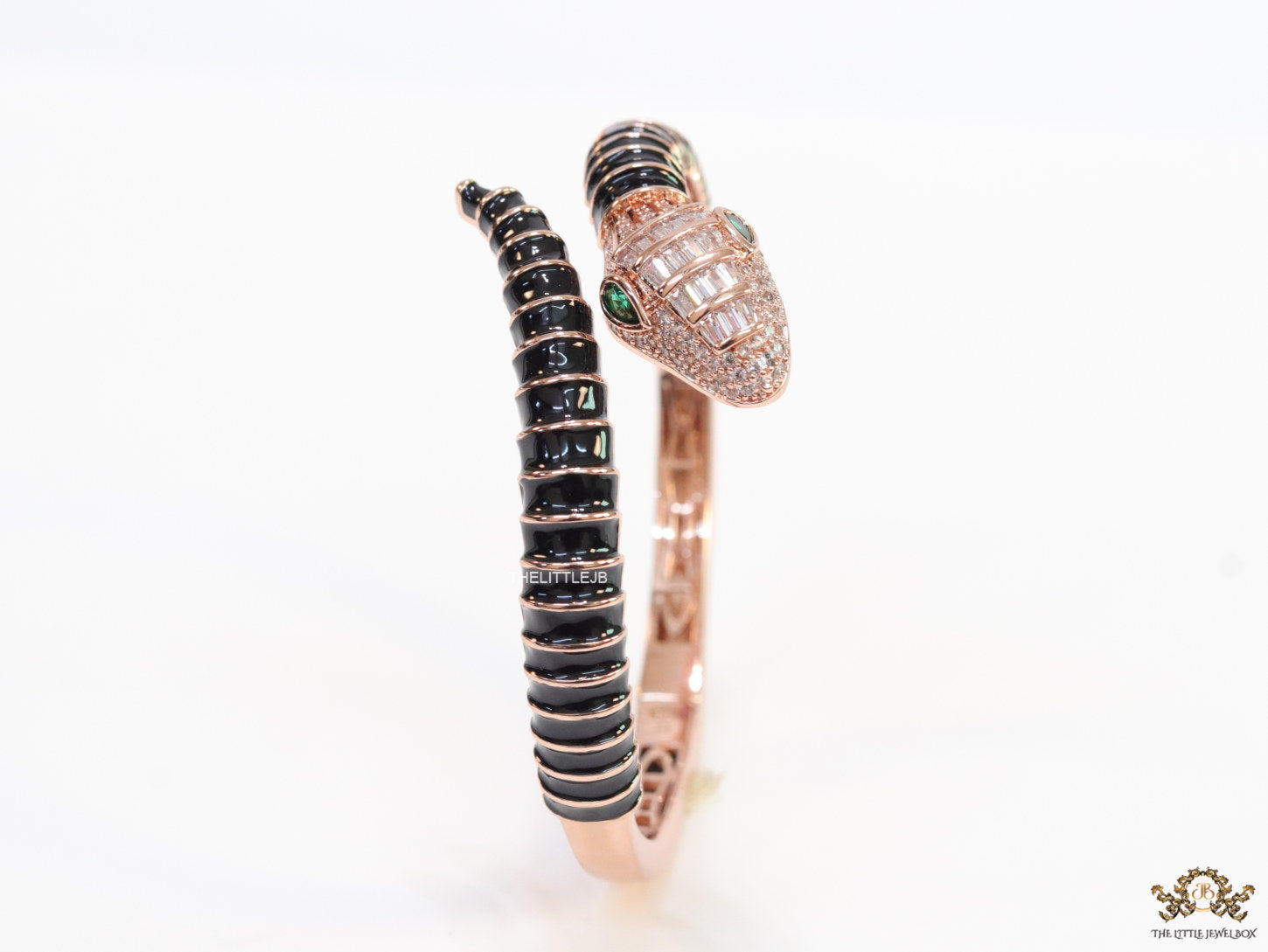 Top open serpentine bracelet in black enamel with rose gold plated details and cubic zirconia stones head
