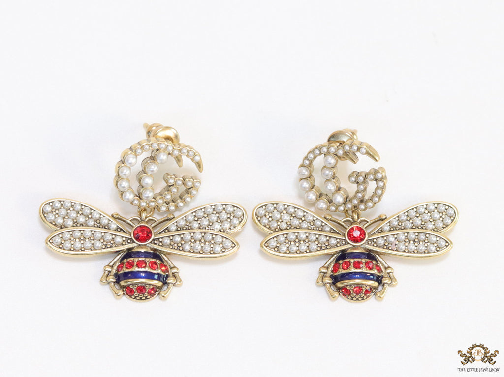 Pearl twin G earrings with pearl and multi cz bees in golden finish