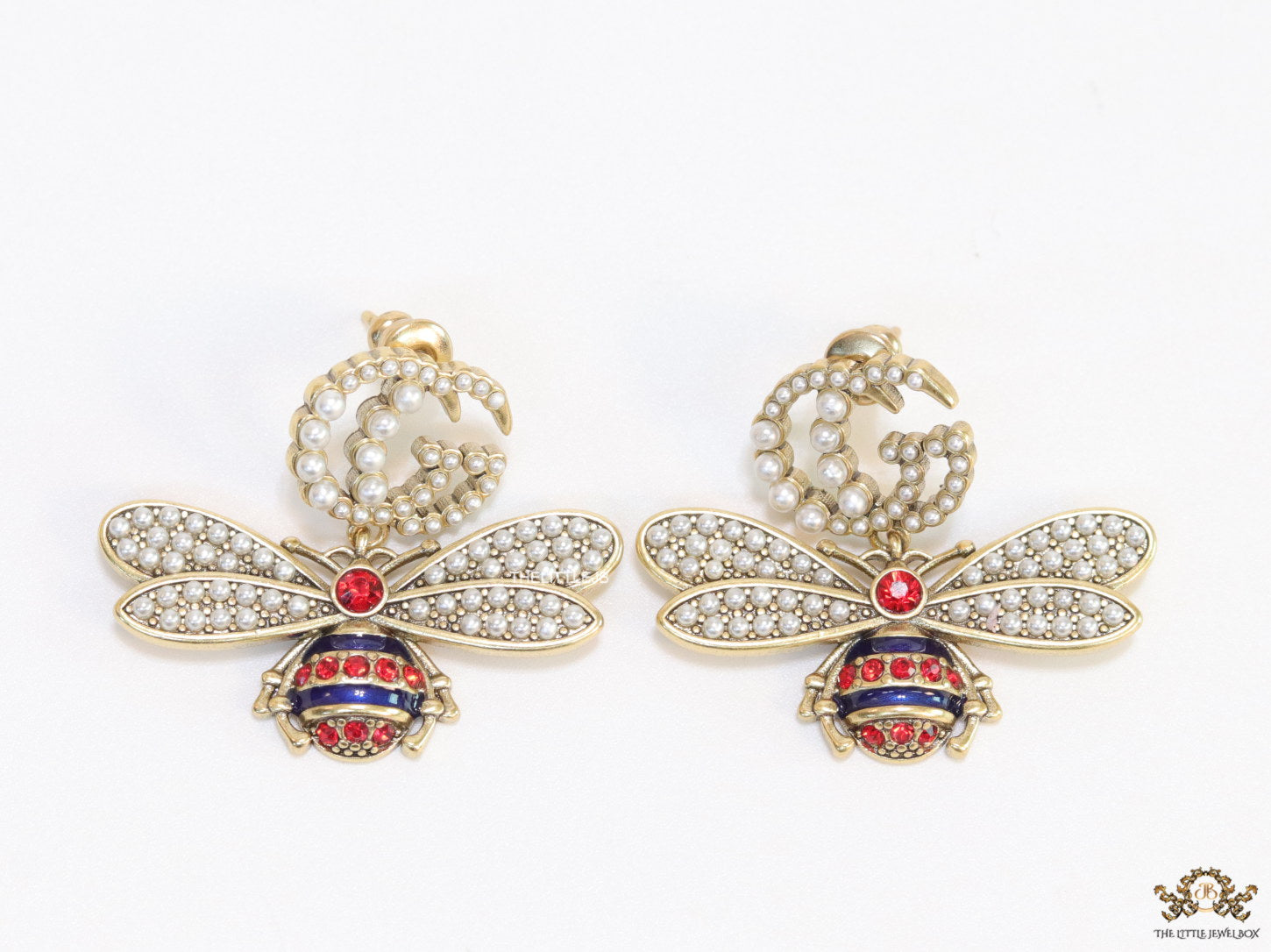Pearl twin G earrings with pearl and multi cz bees in golden finish