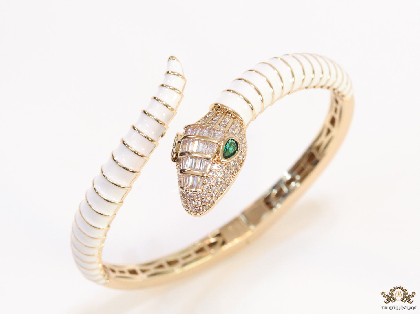 Top open serpentine bracelet in white enamel with rose gold plated details and cubic zirconia stones head
