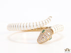 Top open serpentine bracelet in white enamel with rose gold plated details and cubic zirconia stones head
