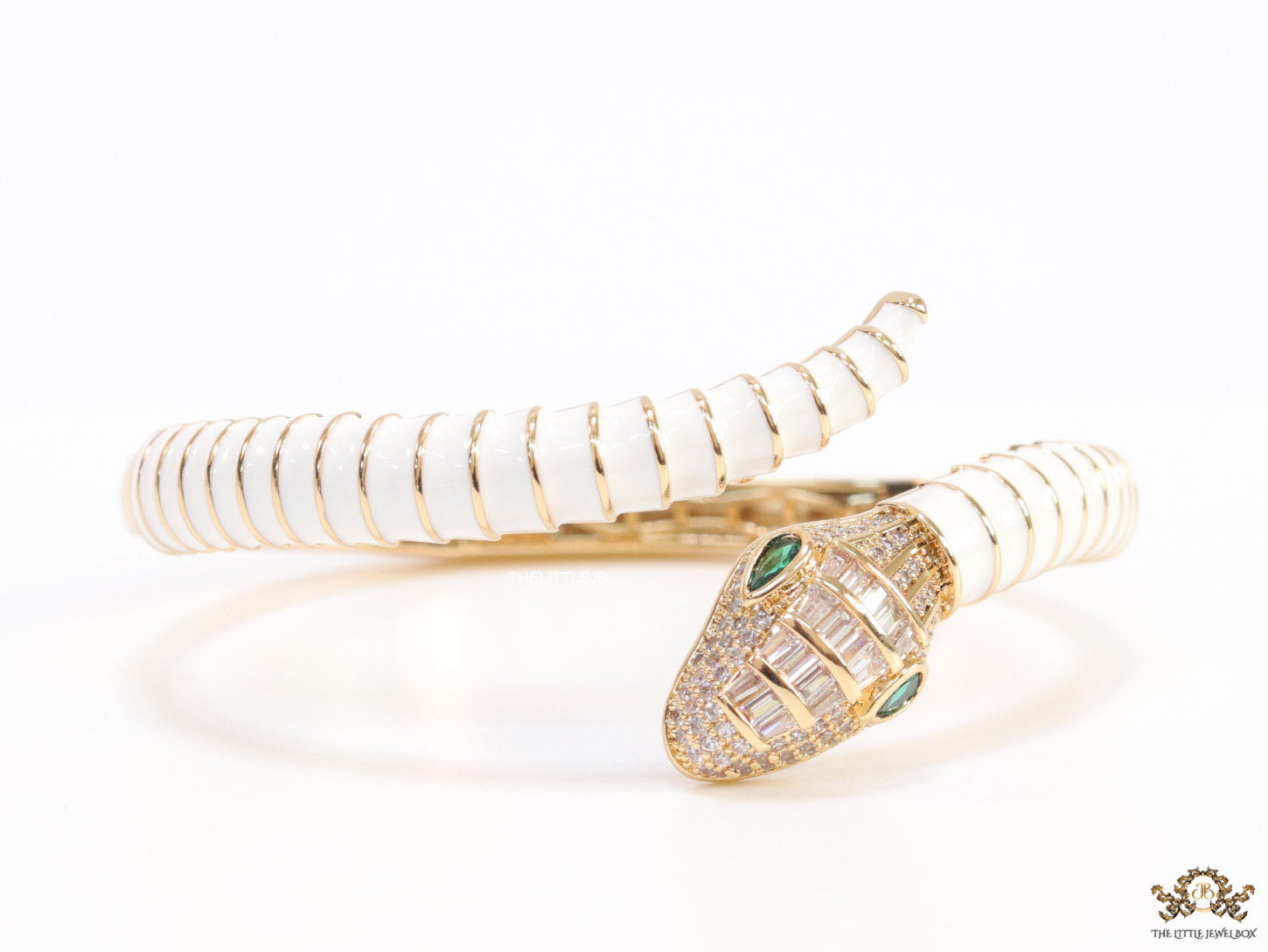 Top open serpentine bracelet in white enamel with rose gold plated details and cubic zirconia stones head