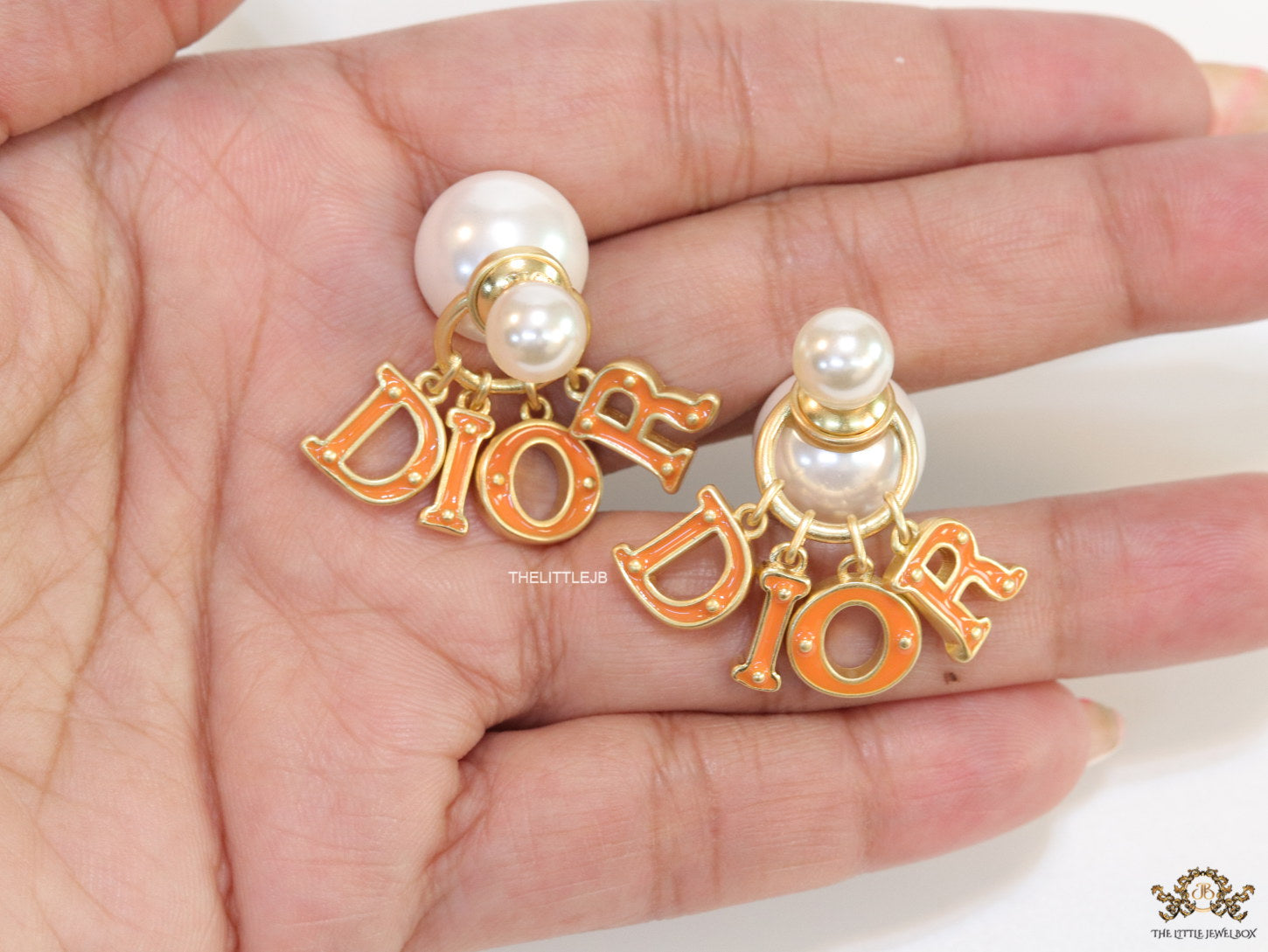 Pearl bomber earrings with golden and orange alphabet drop charms