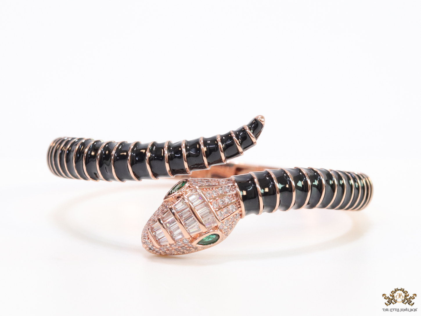 Top open serpentine bracelet in black enamel with rose gold plated details and cubic zirconia stones head