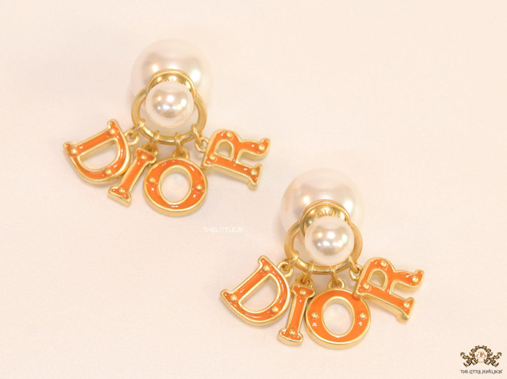 Pearl bomber earrings with golden and orange alphabet drop charms