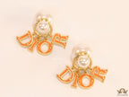 Pearl bomber earrings with golden and orange alphabet drop charms