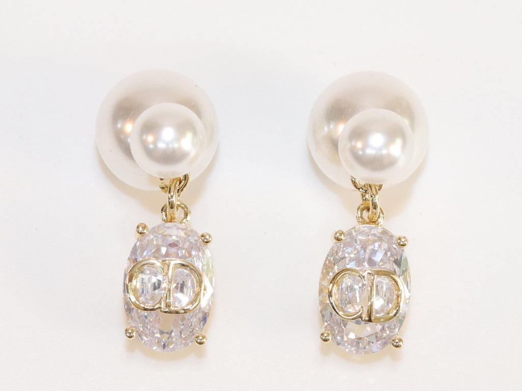 Alphabet C and D dangling stone pearl studs in platinum finish