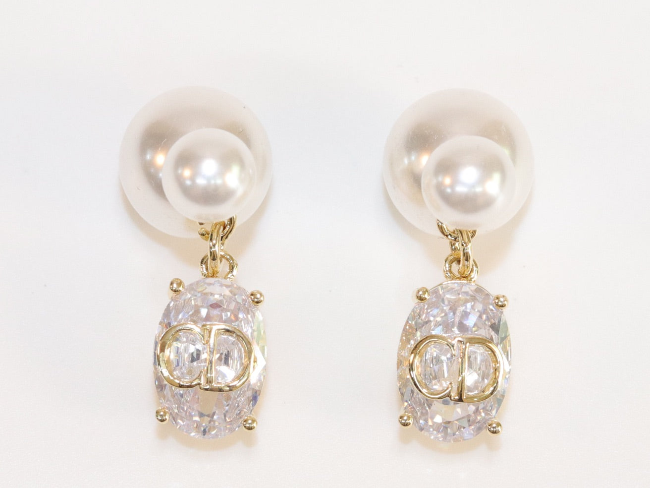 Alphabet C and D dangling stone pearl studs in platinum finish