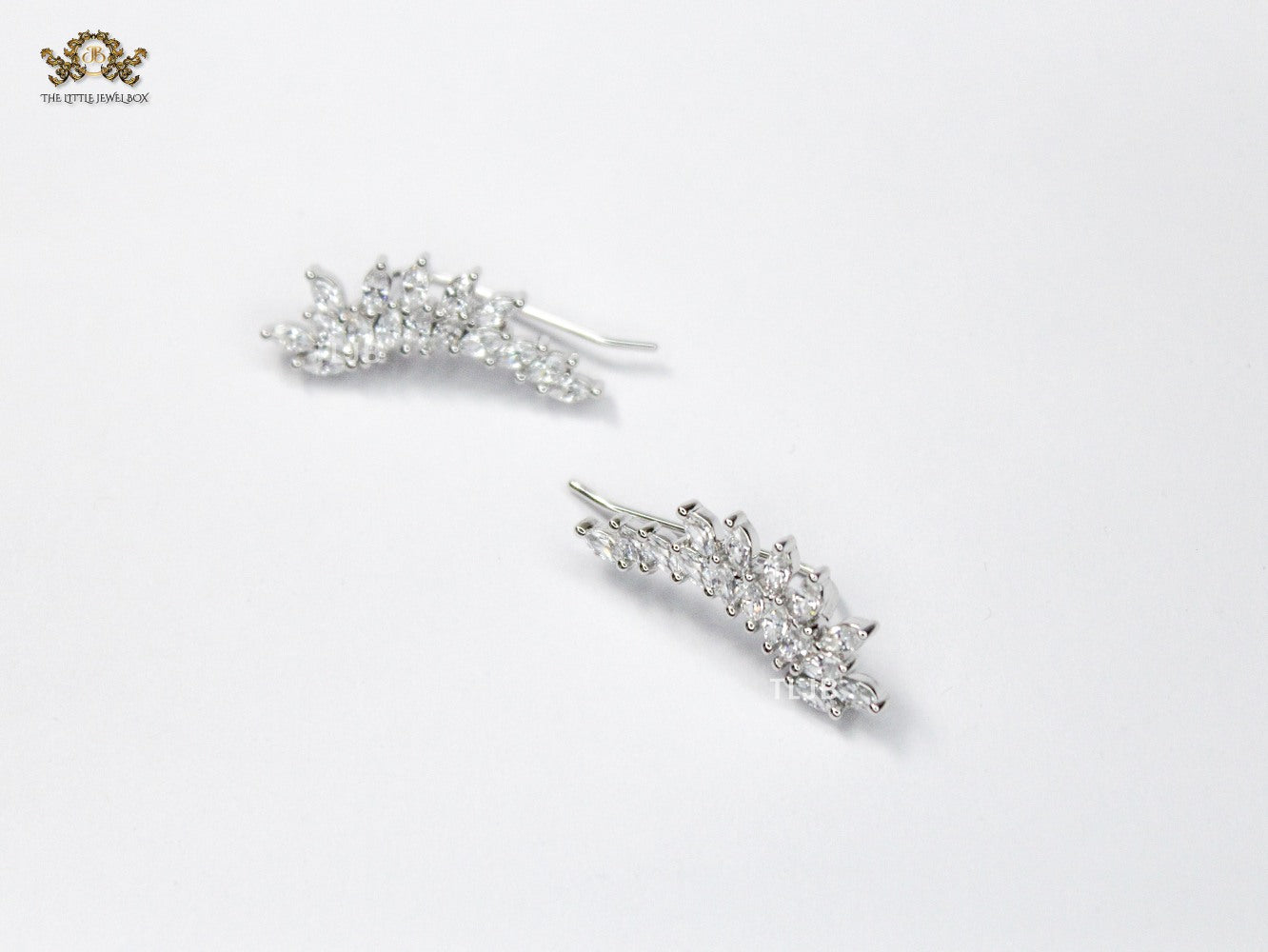 Diamond-Studded Leaf Climber Earrings in silver