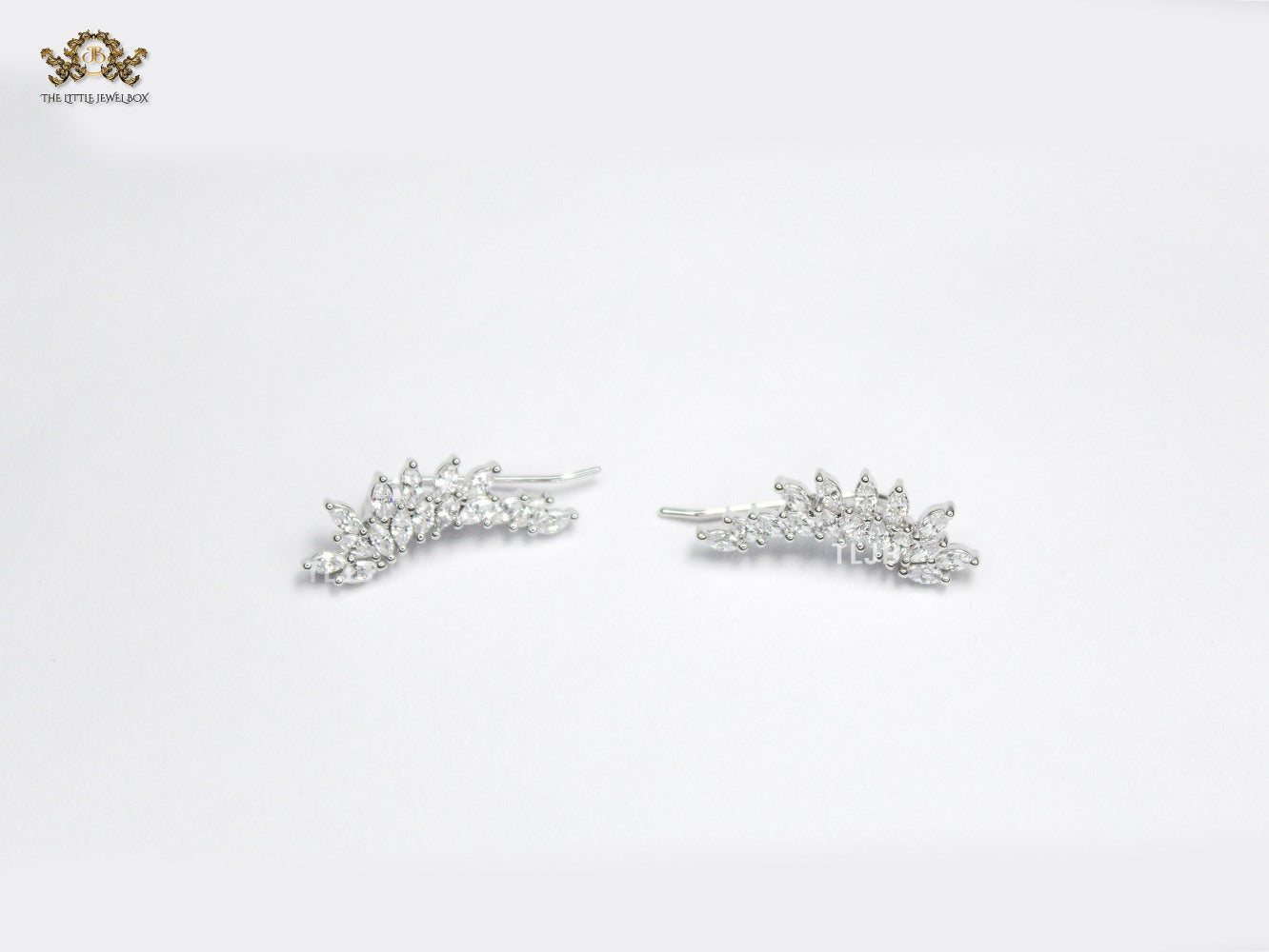 Diamond-Studded Leaf Climber Earrings in silver