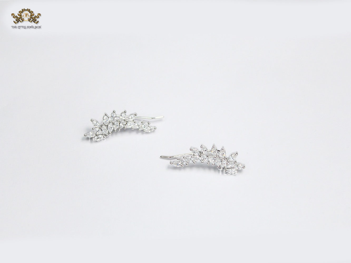 Diamond-Studded Leaf Climber Earrings in silver