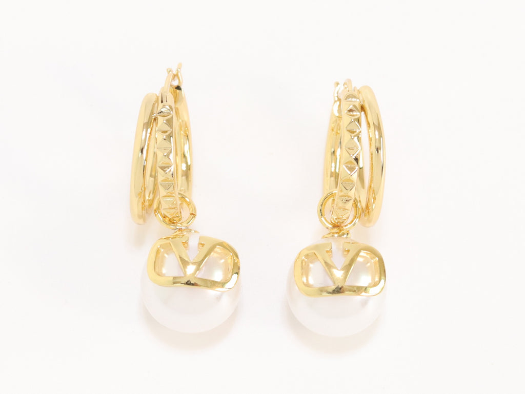 Alphabet V pearl dangling studs in gold finish