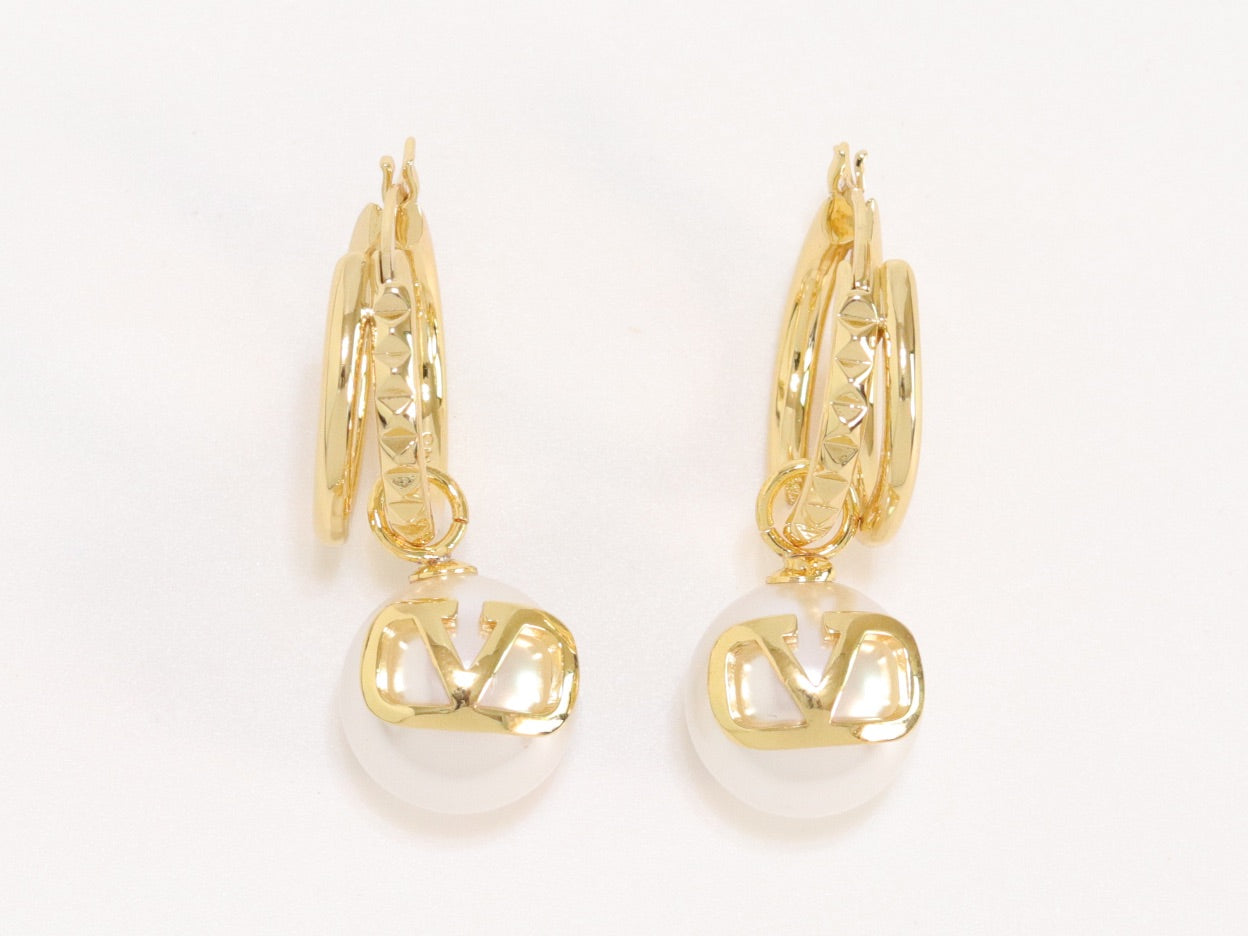 Alphabet V pearl dangling studs in gold finish