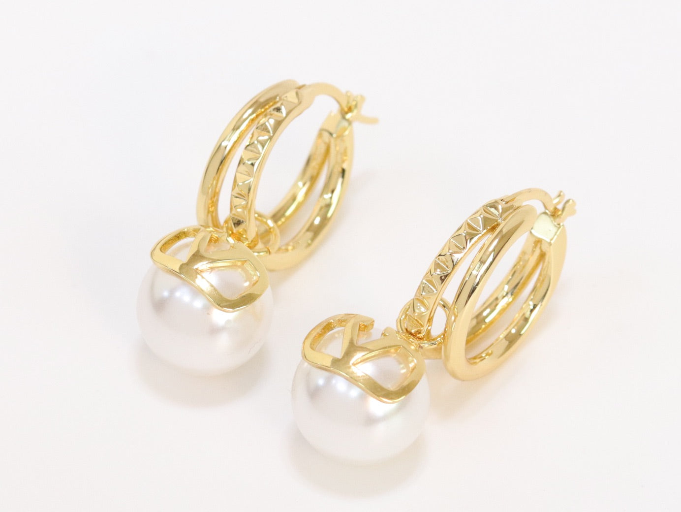 Alphabet V pearl dangling studs in gold finish