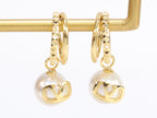 Alphabet V pearl dangling studs in gold finish