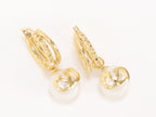 Alphabet V pearl dangling studs in gold finish