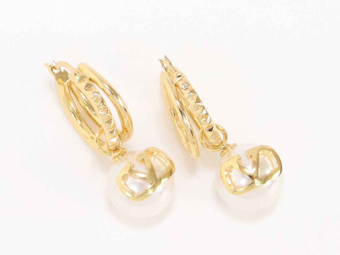 Alphabet V pearl dangling studs in gold finish