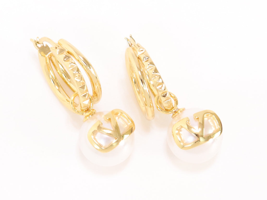 Alphabet V pearl dangling studs in gold finish