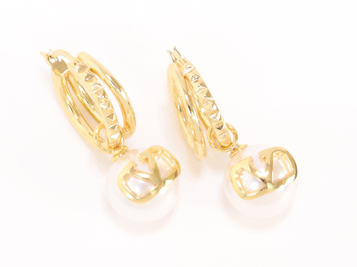 Alphabet V pearl dangling studs in gold finish