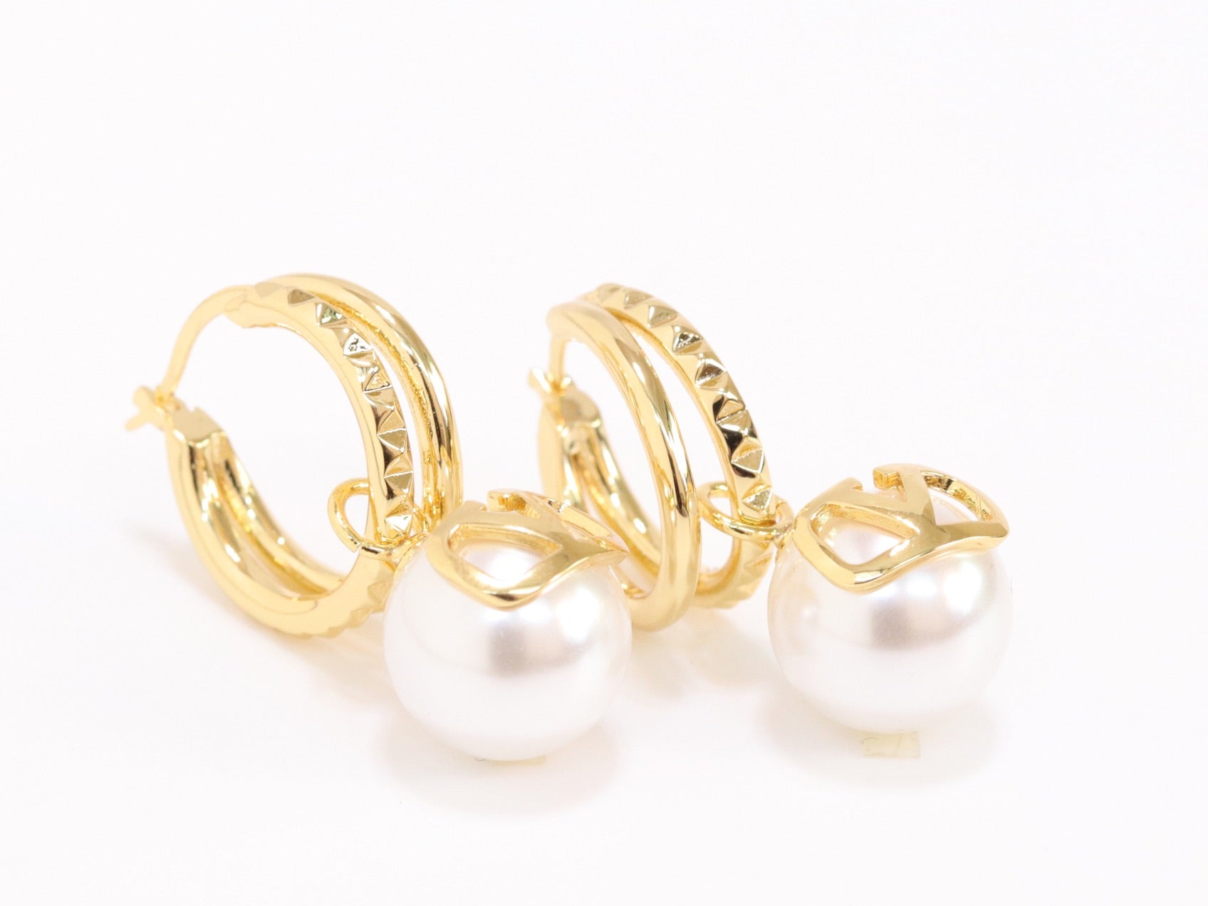 Alphabet V pearl dangling studs in gold finish