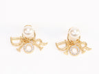 Alphabet CD dangling pearl studs in gold finish with CZ