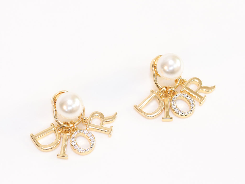 Alphabet CD dangling pearl studs in gold finish with CZ