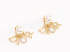 Alphabet CD dangling pearl studs in gold finish with CZ