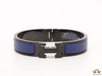 Premium collection band style bracelet in matt blue with black metallic details and black T alphabet motif
