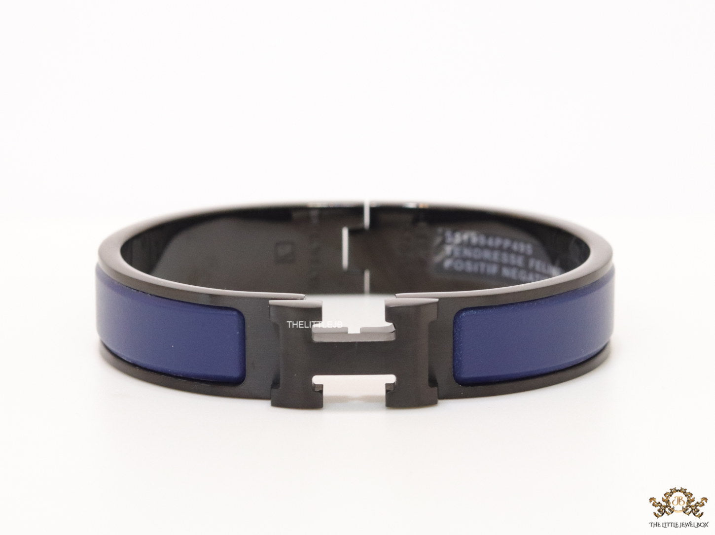 Premium collection band style bracelet in matt blue with black metallic details and black T alphabet motif