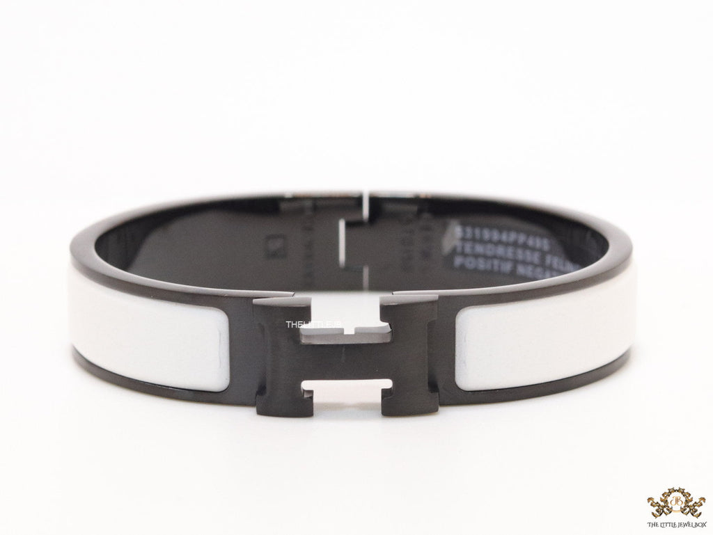 Premium collection band style bracelet in matt white with black metallic details and black T alphabet motif