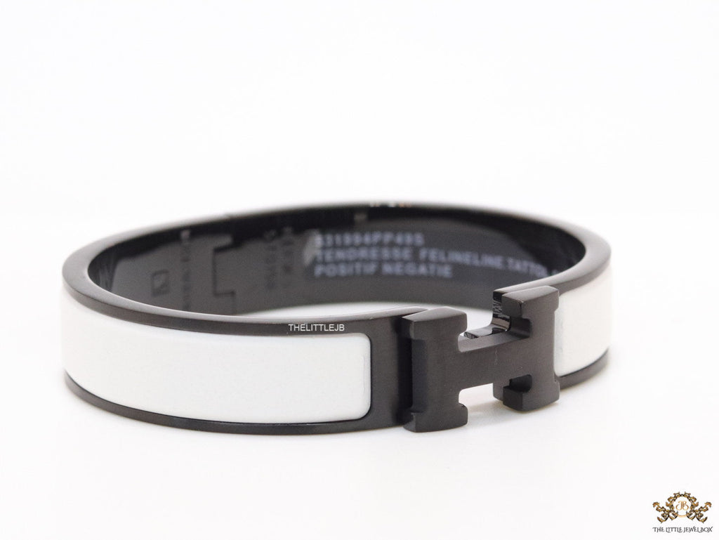 Premium collection band style bracelet in matt white with black metallic details and black T alphabet motif