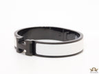 Premium collection band style bracelet in matt white with black metallic details and black T alphabet motif