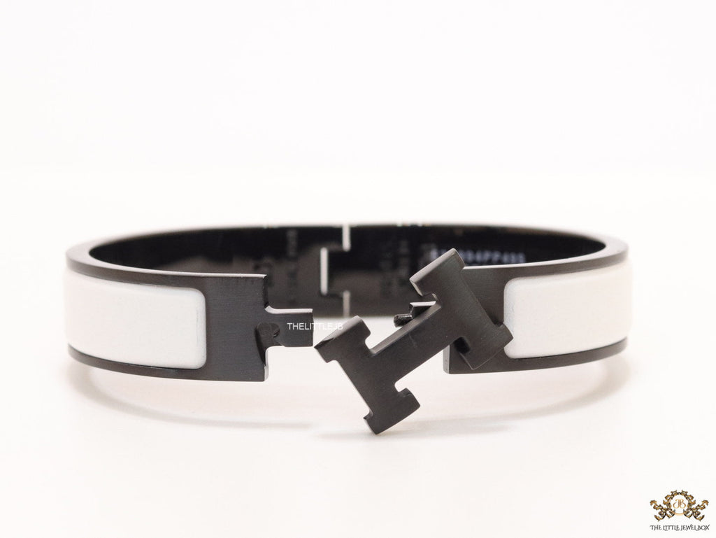 Premium collection band style bracelet in matt white with black metallic details and black T alphabet motif