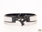 Premium collection band style bracelet in matt white with black metallic details and black T alphabet motif