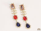 Gold plated cz dangles with red and blue stones and fancy cut cz