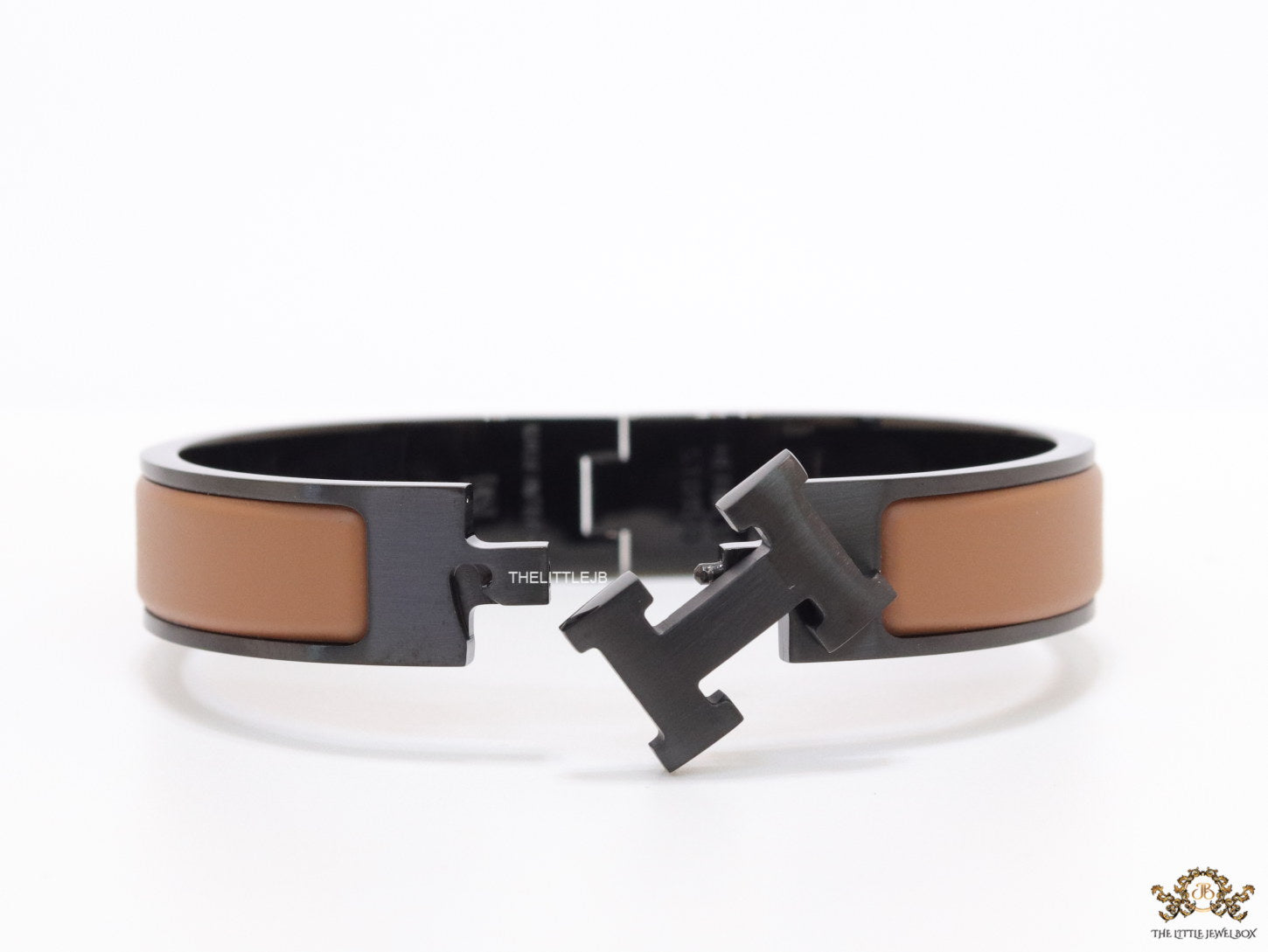Premium collection band style bracelet in matt tan with black metallic details and black T alphabet motif