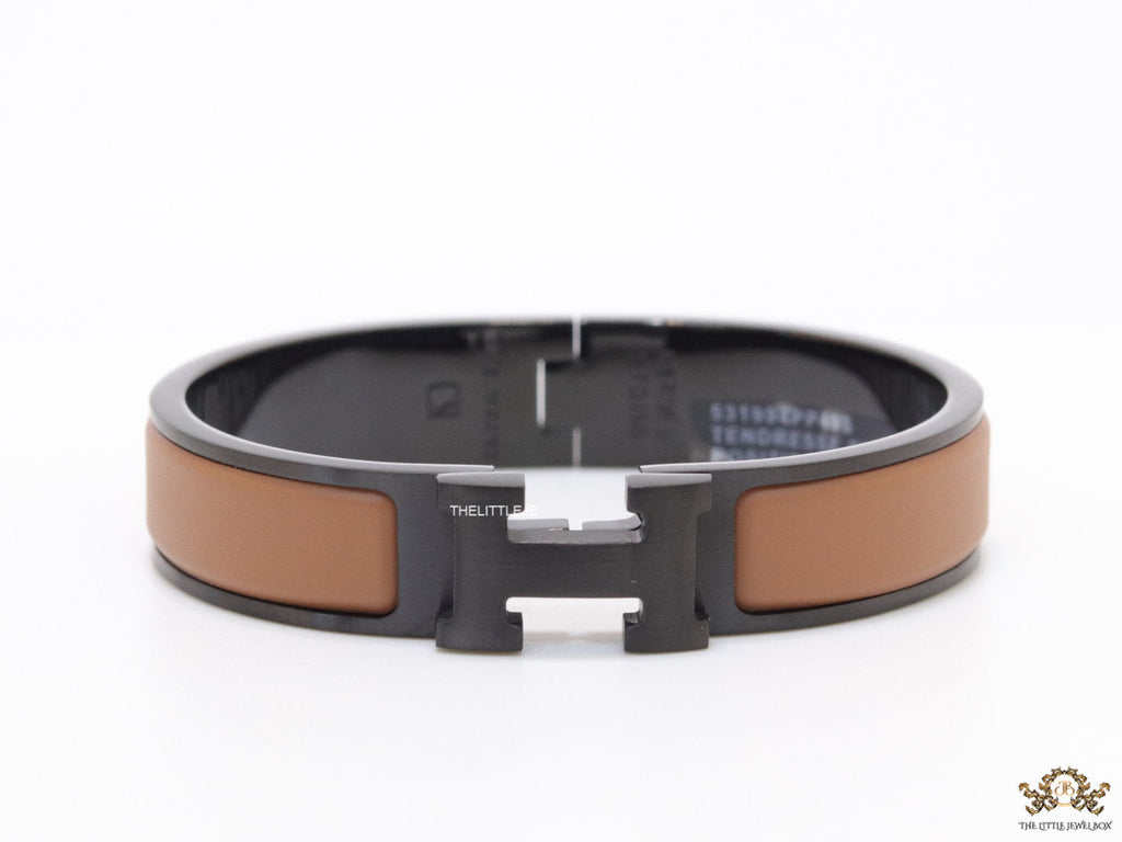 Premium collection band style bracelet in matt tan with black metallic details and black T alphabet motif