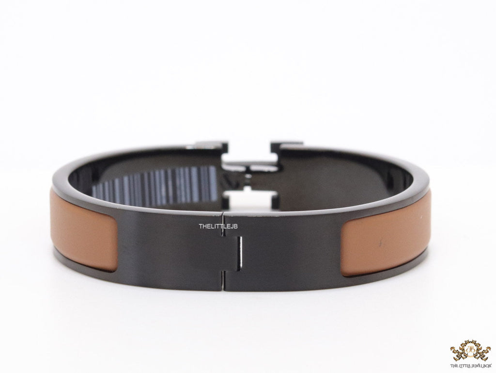 Premium collection band style bracelet in matt tan with black metallic details and black T alphabet motif
