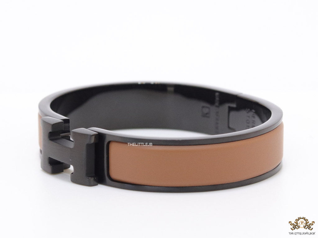 Premium collection band style bracelet in matt tan with black metallic details and black T alphabet motif